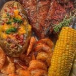 T-Bone steak with jumbo shrimp, loaded baked potato and fresh corn on the cob