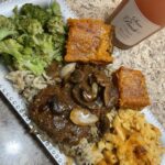 Hamburger steak smothered in gravy , over a bed of wild rice  , macaroni and cheese & steamed broccoli 🥦 with a side of sweet potato cornbread 🫶🏾
