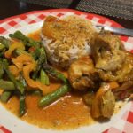 Smothered baked chicken with jasmine rice and sautéed asparagus.