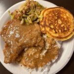 Cabbage, hot water cornbread, smothered pork chops and gravy