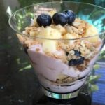 Vegan snack recipe for yogurt topped with fruit and granola