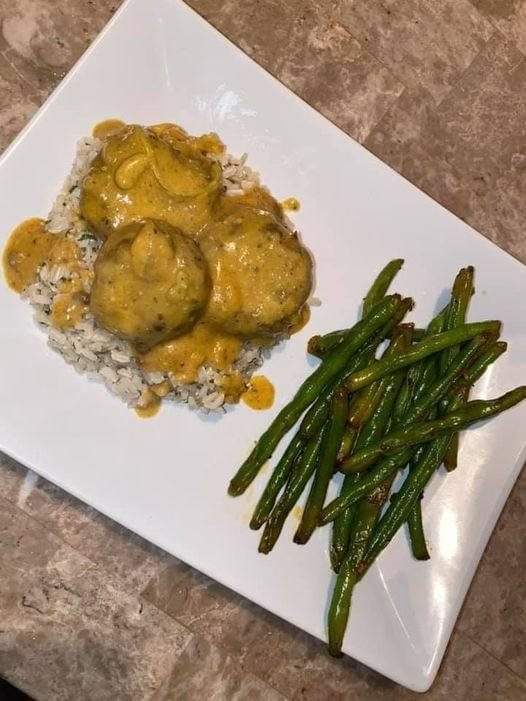 Lentil balls with gravy over some brown rice with parsley